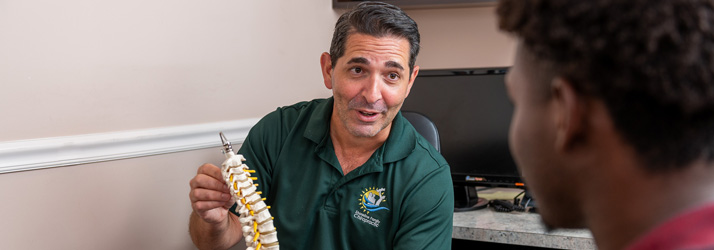 Chiropractor Milford CT Matthew Paterna Consulting With Patient
