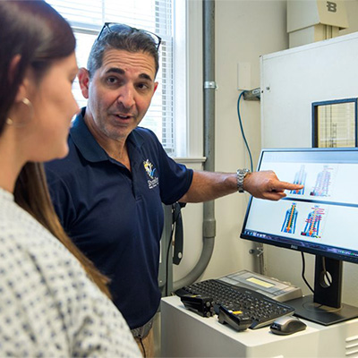 Chiropractor Milford CT Matthew Paterna With Patient Explaining Nerves